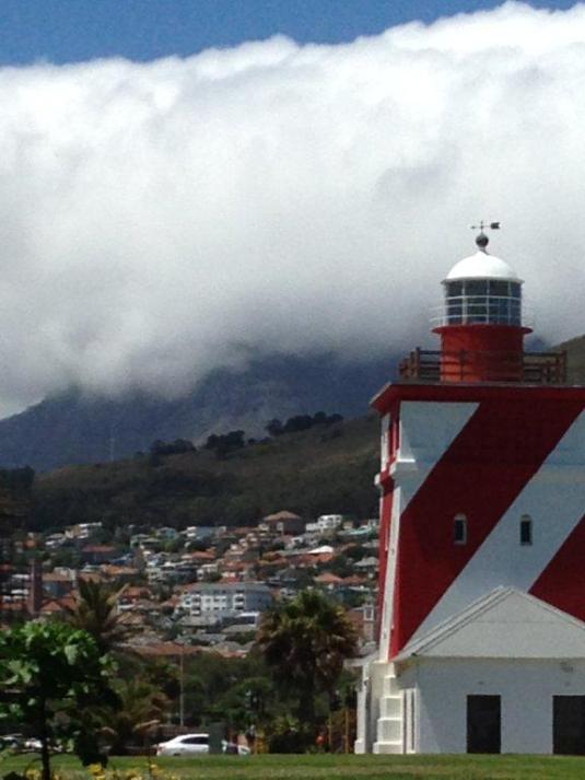 Behind the Mouille Point light house Devil's Peak is completely shrouded in cloud. 